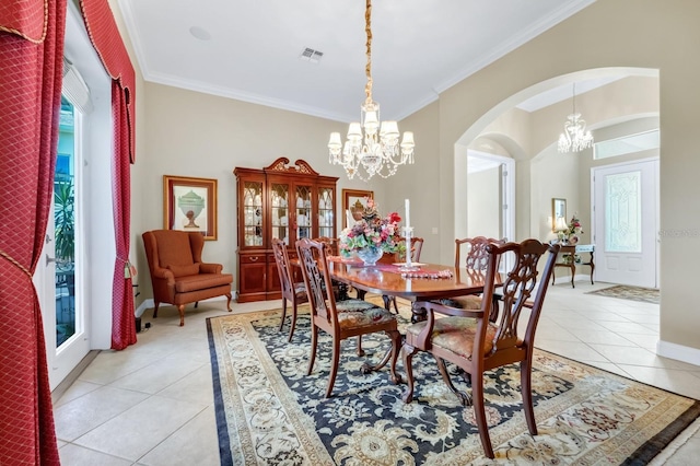 785 Hawks Blf, Clermont, FL 34711 - dining area featuring a chandelier, arched walkways, light tile patterned flooring, crown molding, and healthy amount of natural light
