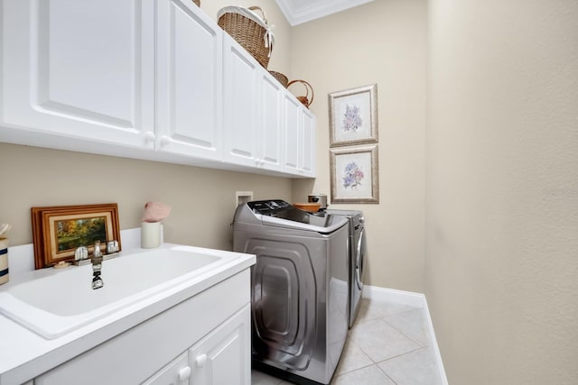 785 Hawks Blf, Clermont, FL 34711 - washroom with washing machine and clothes dryer, cabinet space, light tile patterned flooring, and crown molding