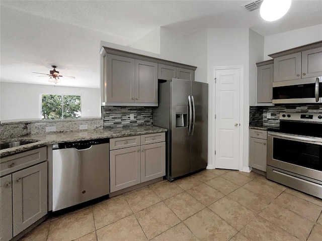 1726 Sunset Ridge Dr, Mascotte, FL 34753 - kitchen featuring stainless steel appliances, gray cabinetry, and decorative backsplash