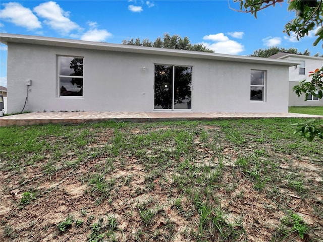 1726 Sunset Ridge Dr, Mascotte, FL 34753 - rear view of house featuring stucco siding, a yard, and a patio