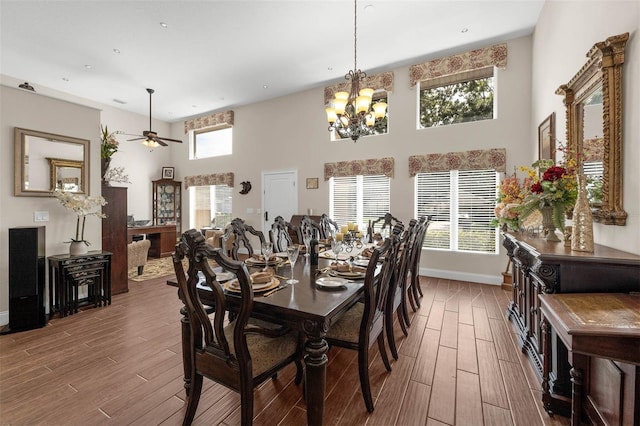 9342 Bay Vista Estates Blvd, Orlando, FL 32836 - dining area featuring wood finished floors, ceiling fan, a towering ceiling, and a chandelier