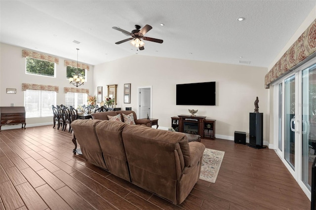 9342 Bay Vista Estates Blvd, Orlando, FL 32836 - living room featuring a chandelier, dark wood-style flooring, lofted ceiling, a ceiling fan, and a textured ceiling