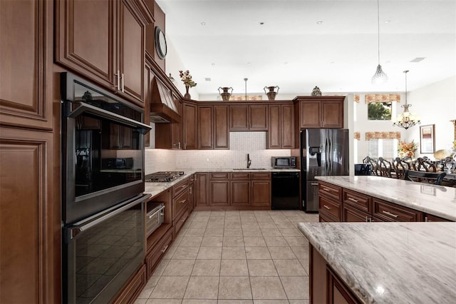 9342 Bay Vista Estates Blvd, Orlando, FL 32836 - kitchen with black appliances, a chandelier, decorative backsplash, decorative light fixtures, and light stone countertops