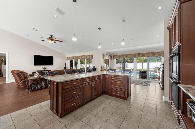 9342 Bay Vista Estates Blvd, Orlando, FL 32836 - kitchen featuring open floor plan, healthy amount of natural light, decorative light fixtures, light tile patterned floors, and lofted ceiling