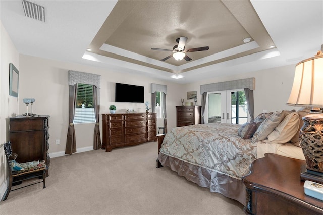 9342 Bay Vista Estates Blvd, Orlando, FL 32836 - bedroom featuring a raised ceiling, access to exterior, french doors, light carpet, and a ceiling fan