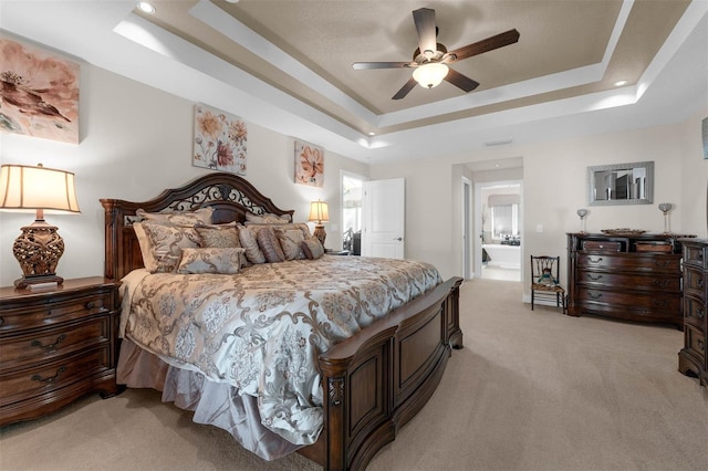 9342 Bay Vista Estates Blvd, Orlando, FL 32836 - bedroom with light carpet, a tray ceiling, a ceiling fan, connected bathroom, and recessed lighting