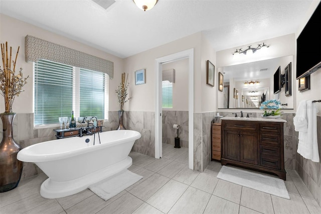 9342 Bay Vista Estates Blvd, Orlando, FL 32836 - full bath with tile walls, plenty of natural light, a soaking tub, vanity, and a wainscoted wall