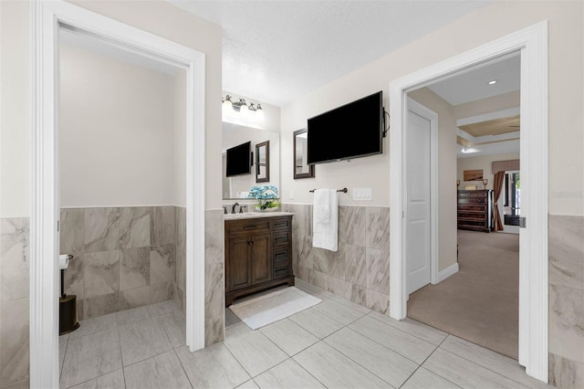 9342 Bay Vista Estates Blvd, Orlando, FL 32836 - bathroom with tile walls, vanity, a wainscoted wall, and tile patterned floors