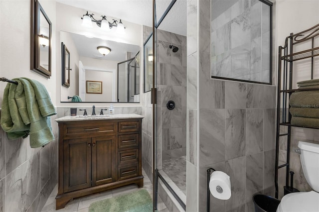 9342 Bay Vista Estates Blvd, Orlando, FL 32836 - full bathroom with tile walls, a shower stall, vanity, and tile patterned flooring