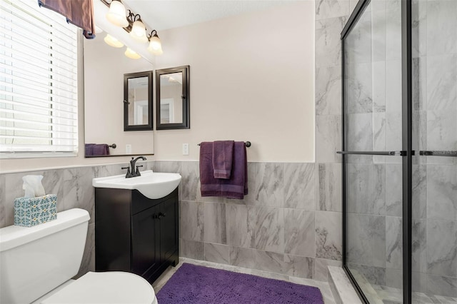 9342 Bay Vista Estates Blvd, Orlando, FL 32836 - bathroom with tile walls, vanity, a shower stall, and wainscoting