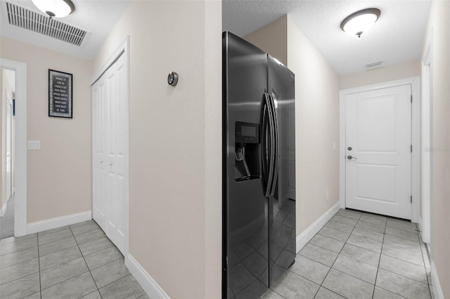 9342 Bay Vista Estates Blvd, Orlando, FL 32836 - kitchen featuring fridge with ice dispenser, light tile patterned floors, and a textured ceiling