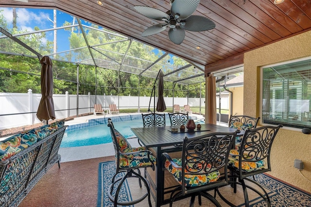 9342 Bay Vista Estates Blvd, Orlando, FL 32836 - fenced backyard featuring a patio area, a ceiling fan, outdoor dining area, and glass enclosure
