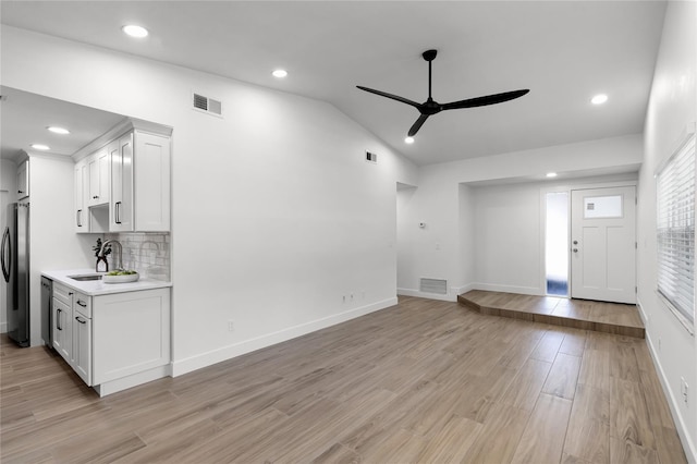 610 Huntly Ln, Winter Springs, FL 32708 - unfurnished living room featuring a ceiling fan, light wood-style flooring, vaulted ceiling, and recessed lighting