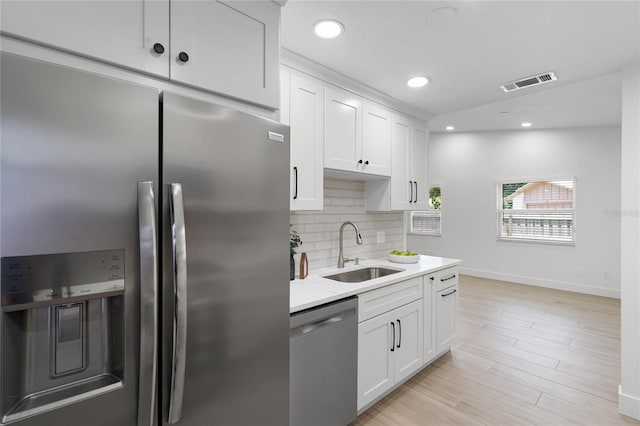 610 Huntly Ln, Winter Springs, FL 32708 - kitchen featuring stainless steel appliances, decorative backsplash, light countertops, recessed lighting, and white cabinetry