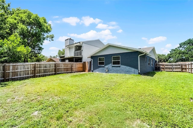 610 Huntly Ln, Winter Springs, FL 32708 - rear view of house featuring a fenced backyard, a chimney, and stucco siding