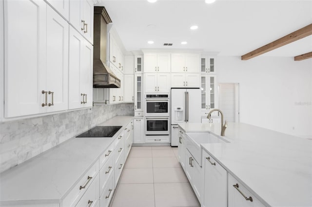 2540 Wembleycross Way, Orlando, FL 32828 - kitchen with white appliances, wall chimney exhaust hood, light tile patterned floors, decorative backsplash, and recessed lighting
