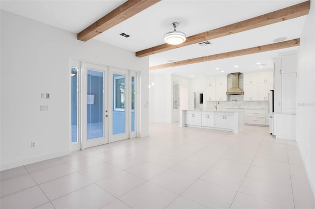 2540 Wembleycross Way, Orlando, FL 32828 - unfurnished living room featuring beam ceiling, recessed lighting, french doors, and light tile patterned floors