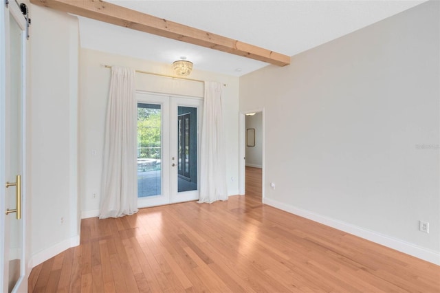 2540 Wembleycross Way, Orlando, FL 32828 - foyer with light wood finished floors, beam ceiling, a barn door, and french doors