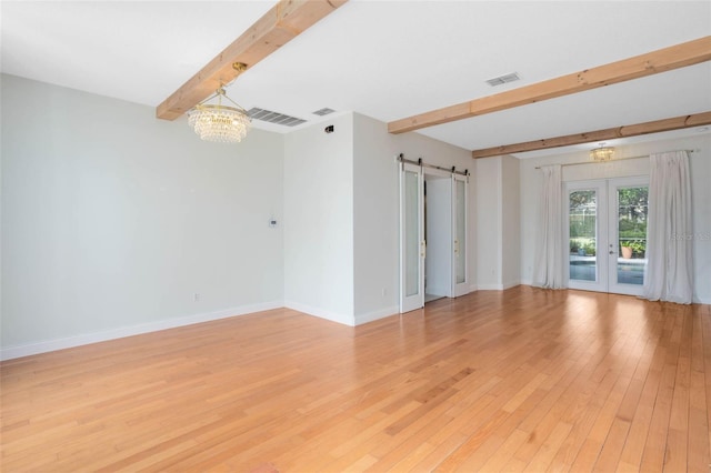 2540 Wembleycross Way, Orlando, FL 32828 - unfurnished room with beamed ceiling, a barn door, french doors, a chandelier, and light wood finished floors