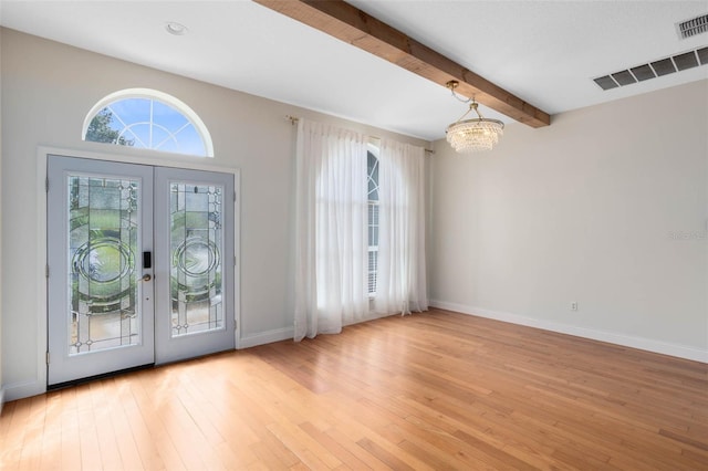 2540 Wembleycross Way, Orlando, FL 32828 - foyer with a chandelier, french doors, light wood-type flooring, and beamed ceiling