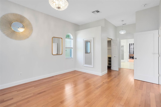 2540 Wembleycross Way, Orlando, FL 32828 - unfurnished room featuring light wood-type flooring and a chandelier