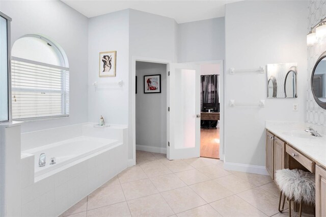 2540 Wembleycross Way, Orlando, FL 32828 - bathroom with vanity, a bath, and tile patterned flooring