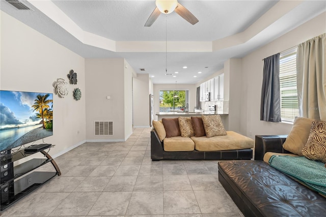 3443 Sagebrush St, Harmony, FL 34773 - living area with a raised ceiling, ceiling fan, and light tile patterned floors