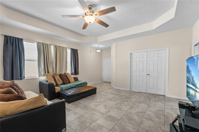 3443 Sagebrush St, Harmony, FL 34773 - living room featuring a raised ceiling, a ceiling fan, and a textured ceiling