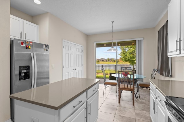 3443 Sagebrush St, Harmony, FL 34773 - kitchen featuring stainless steel appliances, white cabinetry, a center island, pendant lighting, and dark countertops