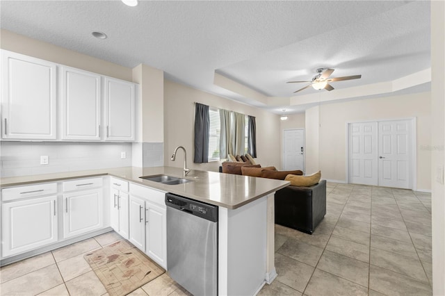 3443 Sagebrush St, Harmony, FL 34773 - kitchen with dishwasher, a peninsula, a raised ceiling, open floor plan, and a textured ceiling