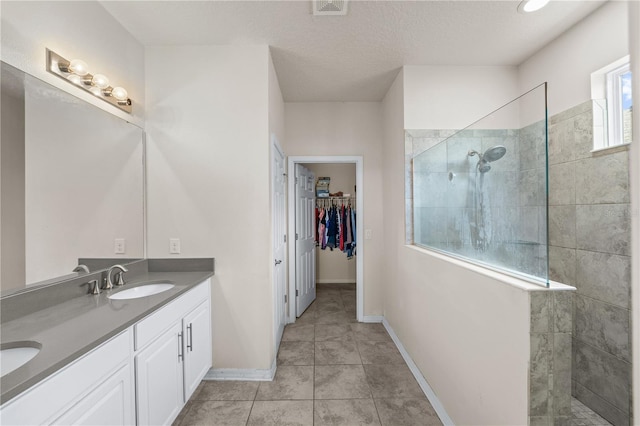 3443 Sagebrush St, Harmony, FL 34773 - full bath featuring double vanity, a walk in shower, a spacious closet, and tile patterned flooring