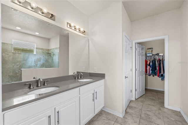 3443 Sagebrush St, Harmony, FL 34773 - full bathroom featuring walk in shower, double vanity, tile patterned floors, and a spacious closet