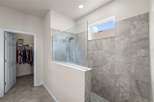 3443 Sagebrush St, Harmony, FL 34773 - bathroom with walk in shower, a walk in closet, and tile patterned flooring