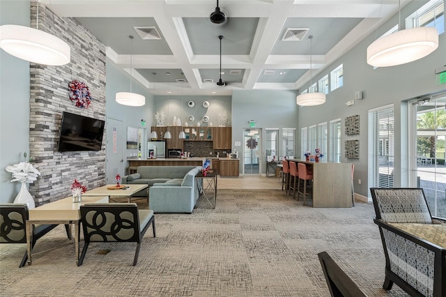 3443 Sagebrush St, Harmony, FL 34773 - living area featuring a high ceiling, coffered ceiling, beam ceiling, and light carpet