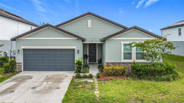 711 Steerview St, Saint Cloud, FL 34771 - ranch-style home with a garage, driveway, stone siding, stucco siding, and a front lawn