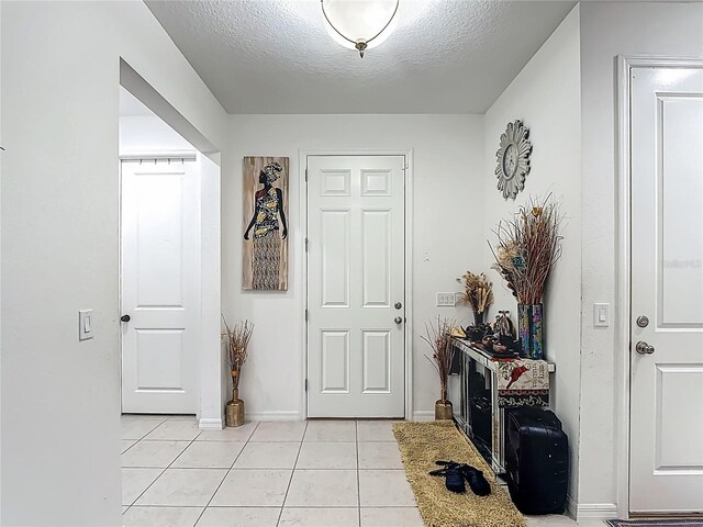 711 Steerview St, Saint Cloud, FL 34771 - foyer entrance featuring light tile patterned flooring and a textured ceiling
