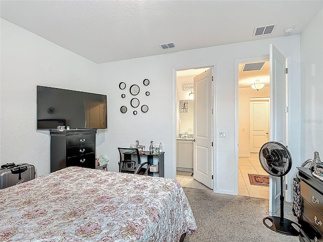 711 Steerview St, Saint Cloud, FL 34771 - carpeted bedroom featuring tile patterned floors and connected bathroom
