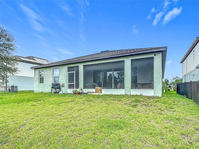 711 Steerview St, Saint Cloud, FL 34771 - back of house featuring a sunroom and stucco siding