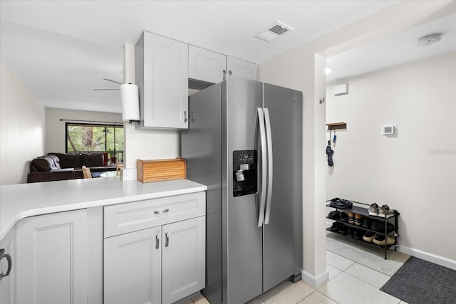 1036 Bonaire Dr Unit 2834, Altamonte Springs, FL 32714 - kitchen with stainless steel fridge with ice dispenser, light countertops, light tile patterned floors, white cabinets, and open floor plan