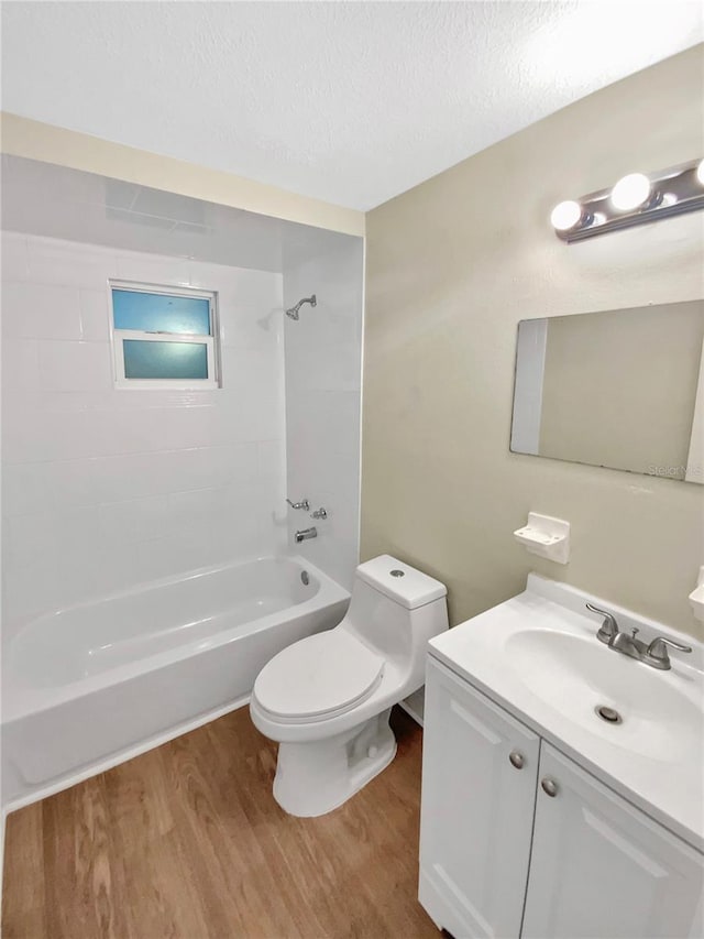4233 Las Vegas Dr, New Port Richey, FL 34653 - bathroom with wood finished floors, vanity, shower / tub combination, and a textured ceiling