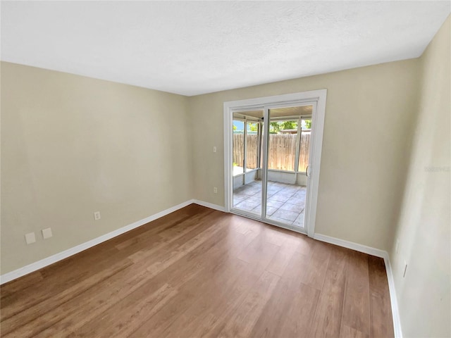 4233 Las Vegas Dr, New Port Richey, FL 34653 - empty room with wood finished floors and baseboards