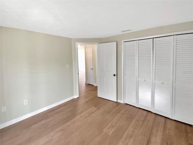 4233 Las Vegas Dr, New Port Richey, FL 34653 - unfurnished bedroom featuring light wood-style floors and a closet