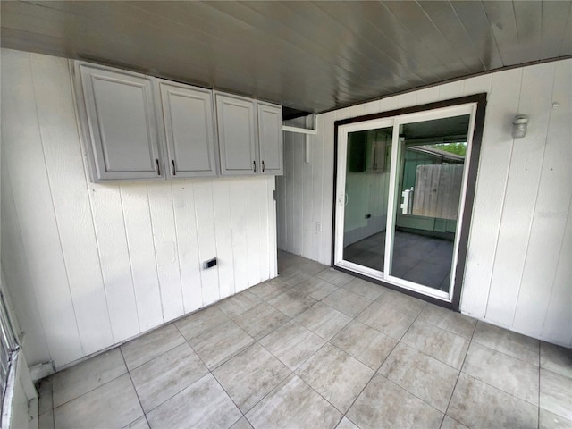 4233 Las Vegas Dr, New Port Richey, FL 34653 - empty room with light tile patterned floors and wood walls