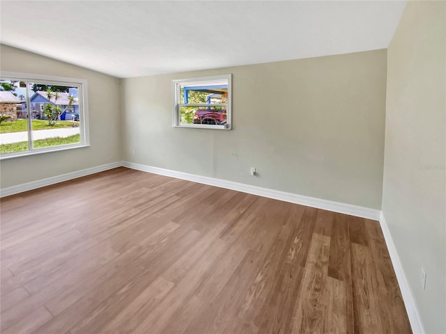 4233 Las Vegas Dr, New Port Richey, FL 34653 - unfurnished room with wood finished floors and plenty of natural light