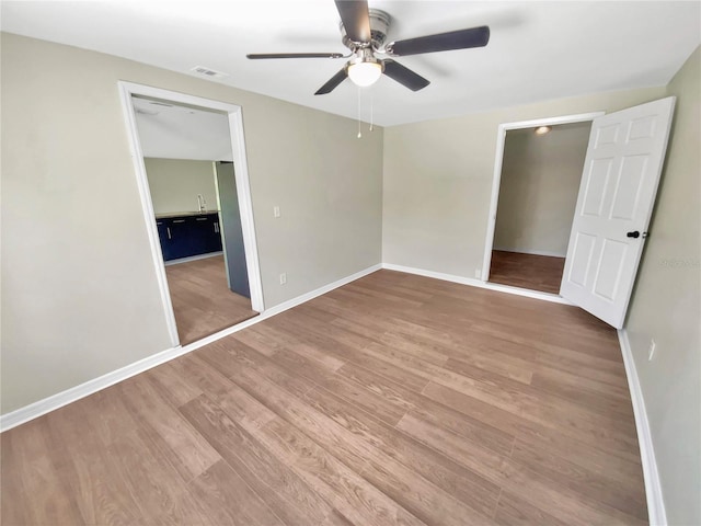 4233 Las Vegas Dr, New Port Richey, FL 34653 - unfurnished bedroom with wood finished floors and ceiling fan