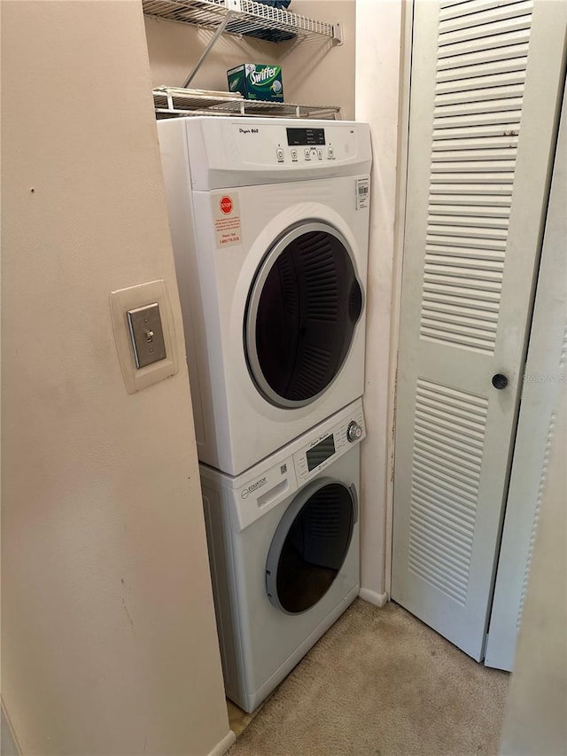 3279 Westridge Blvd Unit 204, Orlando, FL 32822 - washroom with stacked washer / dryer and light colored carpet