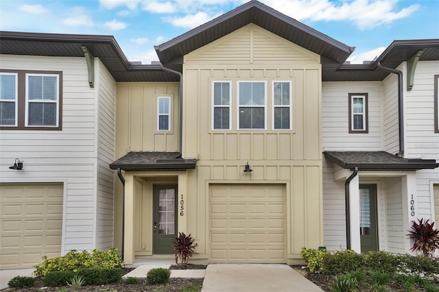 1056 Plantation Ln, Davenport, FL 33896 - townhome / multi-family property featuring board and batten siding, an attached garage, and driveway