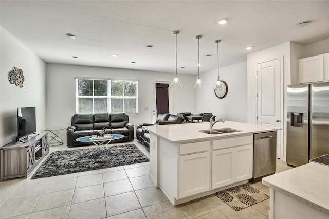 1056 Plantation Ln, Davenport, FL 33896 - kitchen with stainless steel appliances, white cabinets, light countertops, open floor plan, and pendant lighting