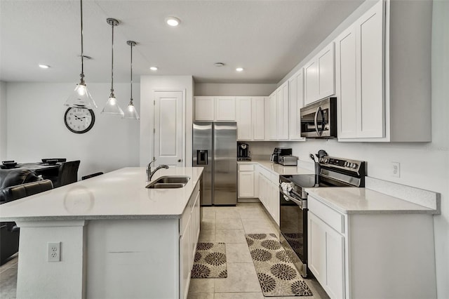 1056 Plantation Ln, Davenport, FL 33896 - kitchen with stainless steel appliances, light countertops, recessed lighting, white cabinets, and pendant lighting