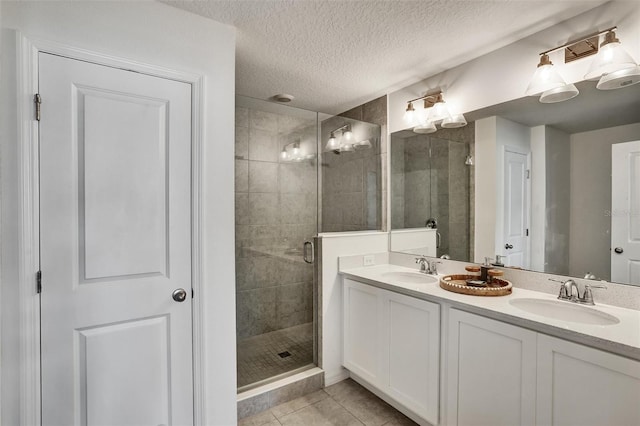 1056 Plantation Ln, Davenport, FL 33896 - full bath featuring a shower stall, double vanity, tile patterned flooring, and a textured ceiling